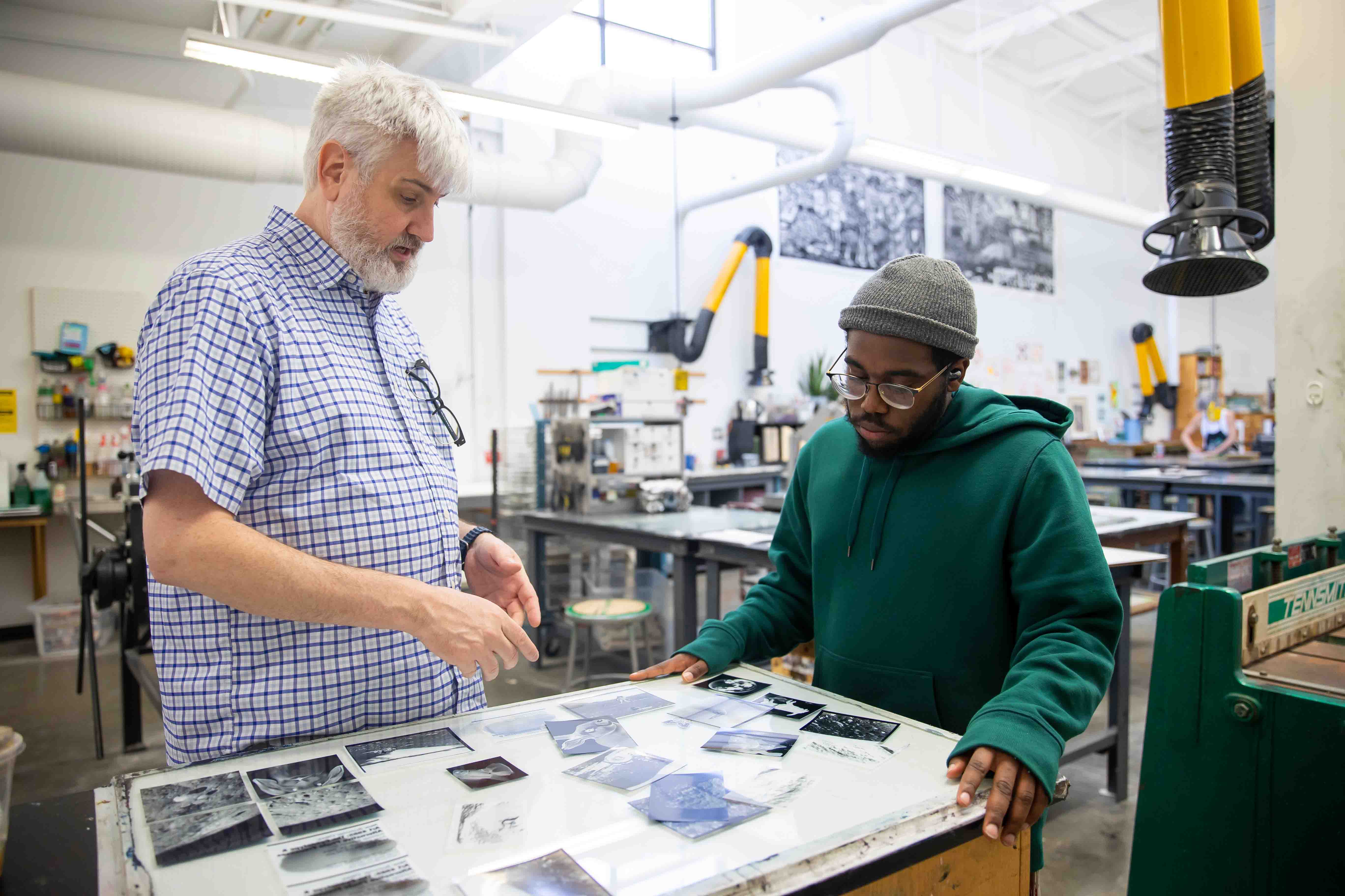 professor discussing a student's art project with him