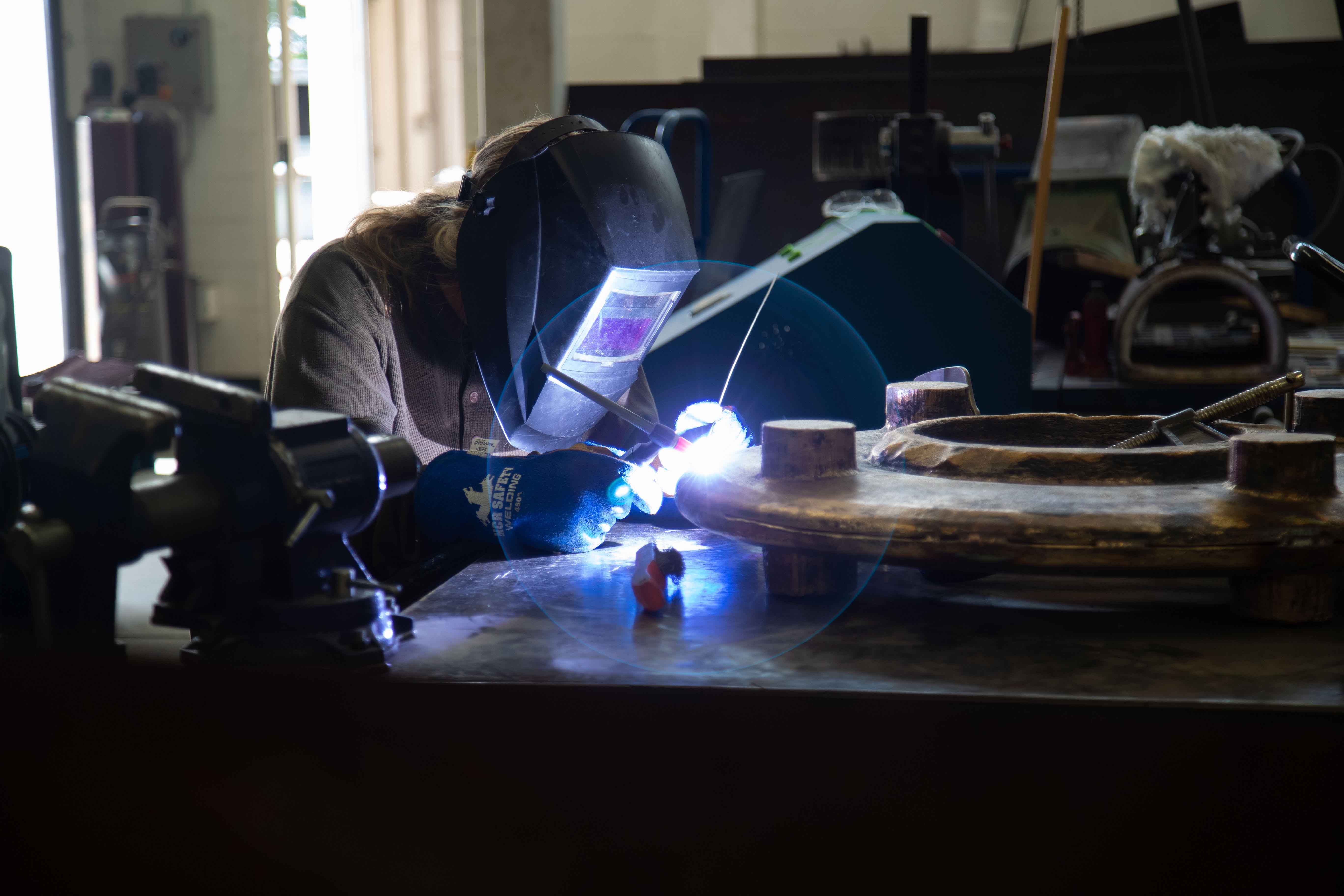 Trinity Dendy works on her sculpture "What It Isn't" at the Visual Arts Building