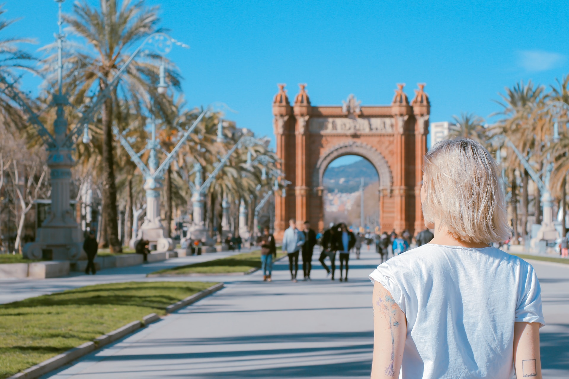 woman standing on road near the Arco de Triunfo de Barcelona in Spain
