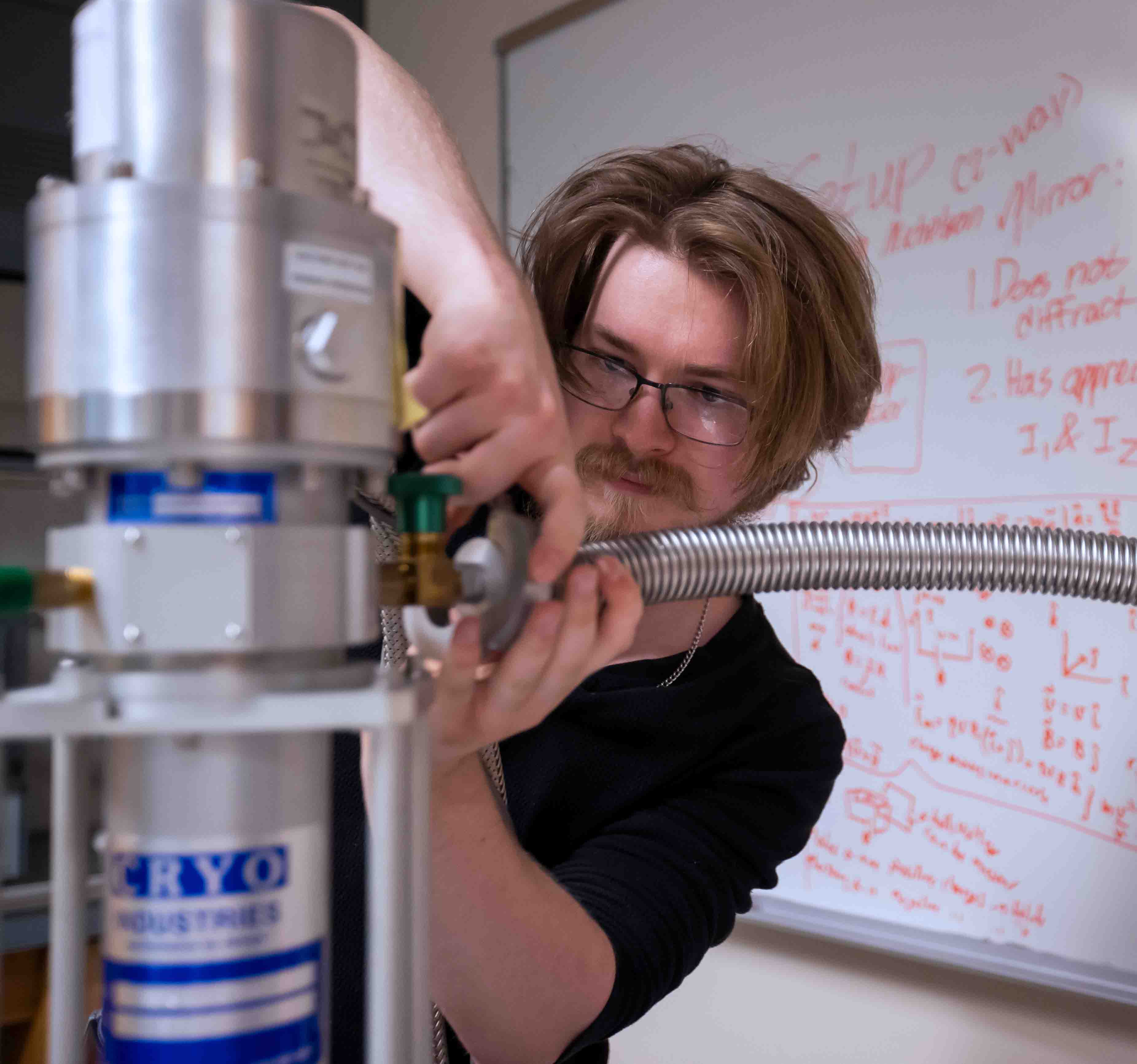 Physics student running an experiment