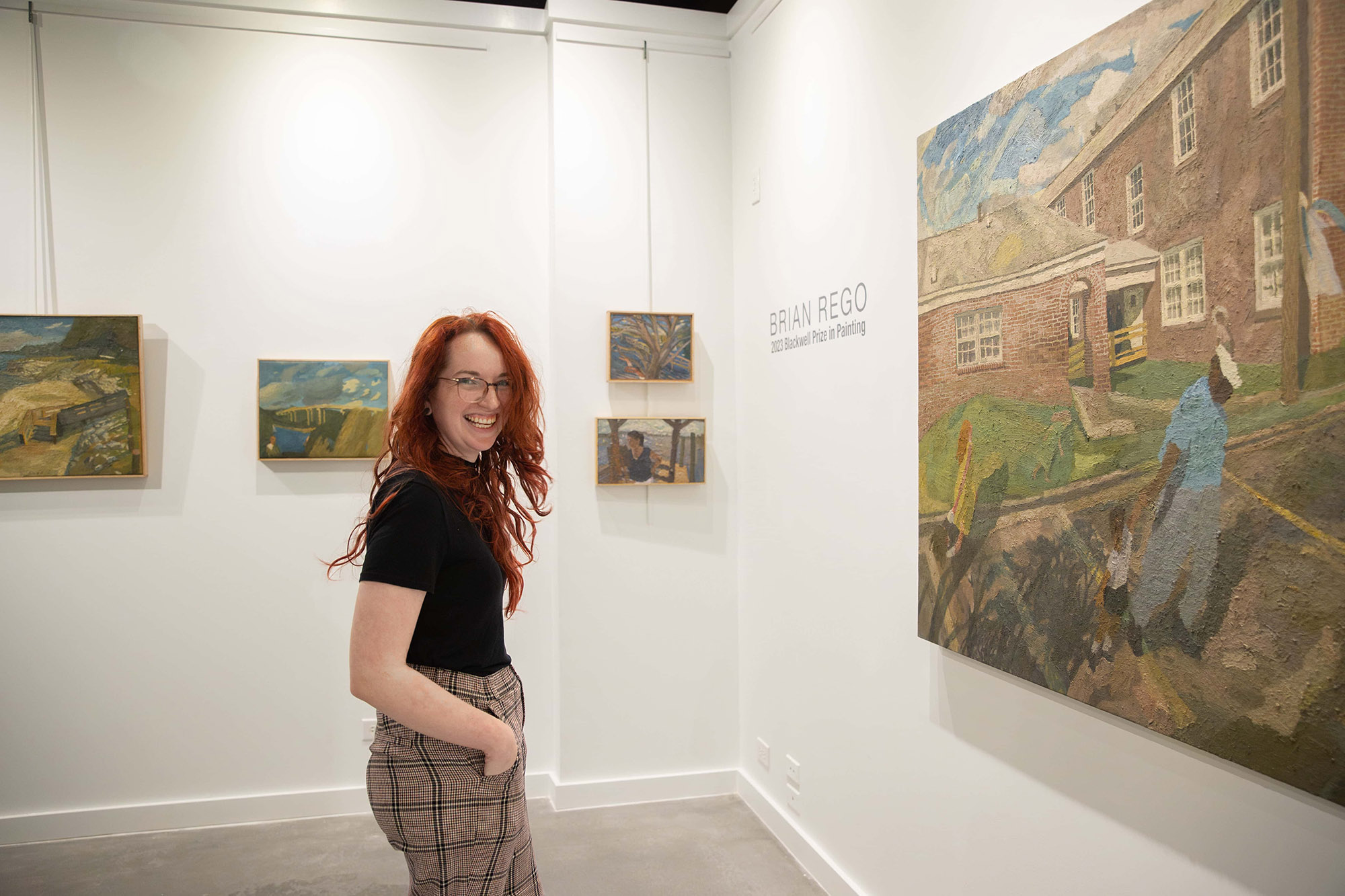 Student smiling in art gallery.