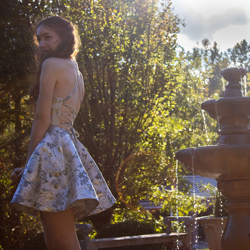 photo of femail figure next to fountain