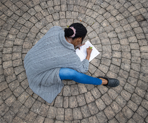 student drawing on pavement
