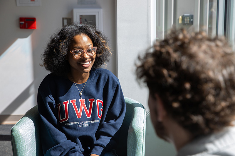 female student seated in conference room