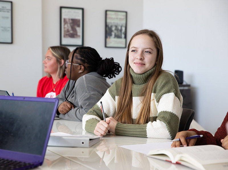 female student seated in conference room