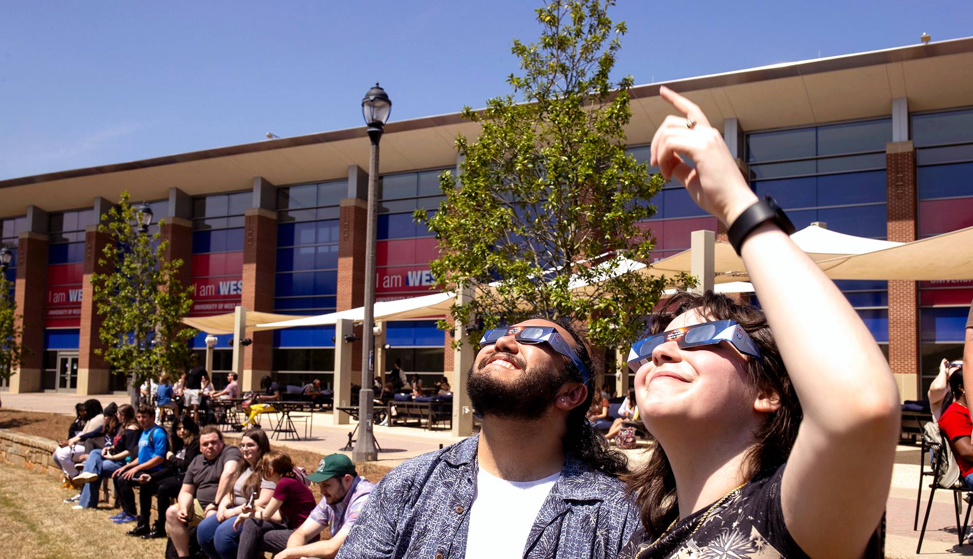 Students watching the eclipse with glasses.
