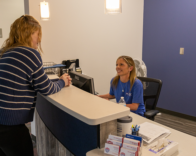 Student checking in with a staff member.