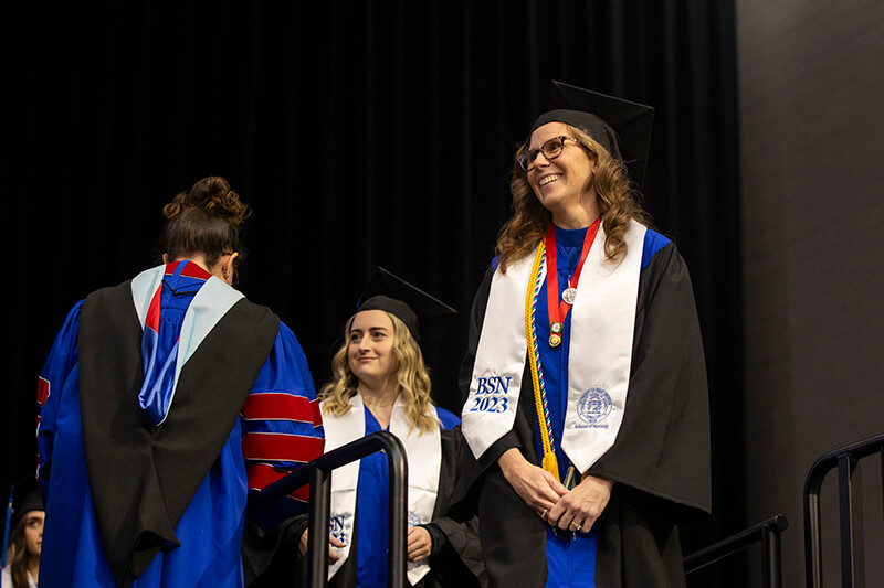 沙巴官网 graduate walking across the stage at 沙巴官网's Fall 2023 Commencement ceremonies