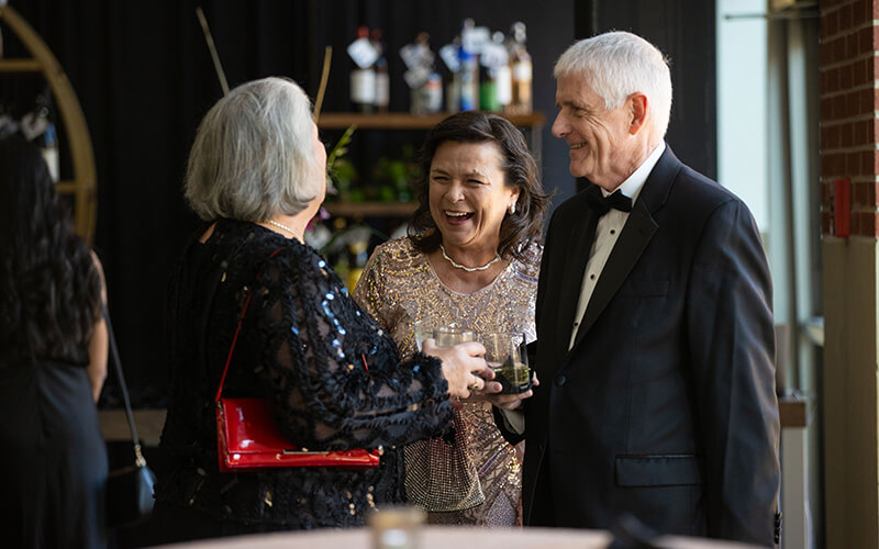 Celebrants laughing at 沙巴官网's Presidential Black Tie Gala