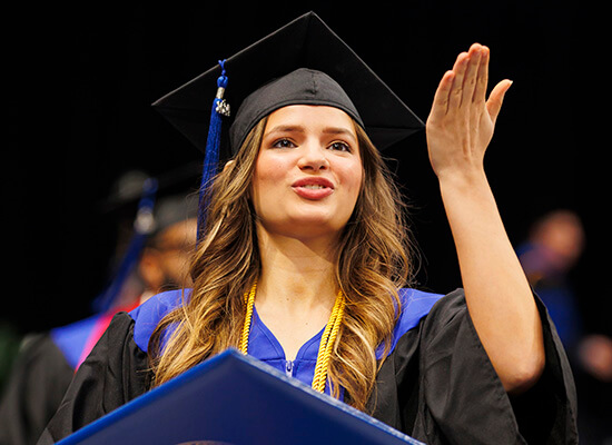 A graduate celebrates at 沙巴官网 commencement