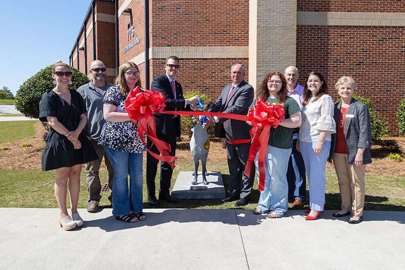 From left to right: Brandy Barker, UWG faculty and executive director for creative services; Ryan Lamfers, UWG senior lecturer of art: sculpture and foundations; Vanessa Benefield, student; Dr. Brendan Kelly, UWG president; Scott Cowart, Carroll County Schools superintendent; Brianna Henry, student; Bryant Turner, Board of Education chairman; Charity Aaron, CCS director of partnerships and communication; and Lawana Knight, BOE member.