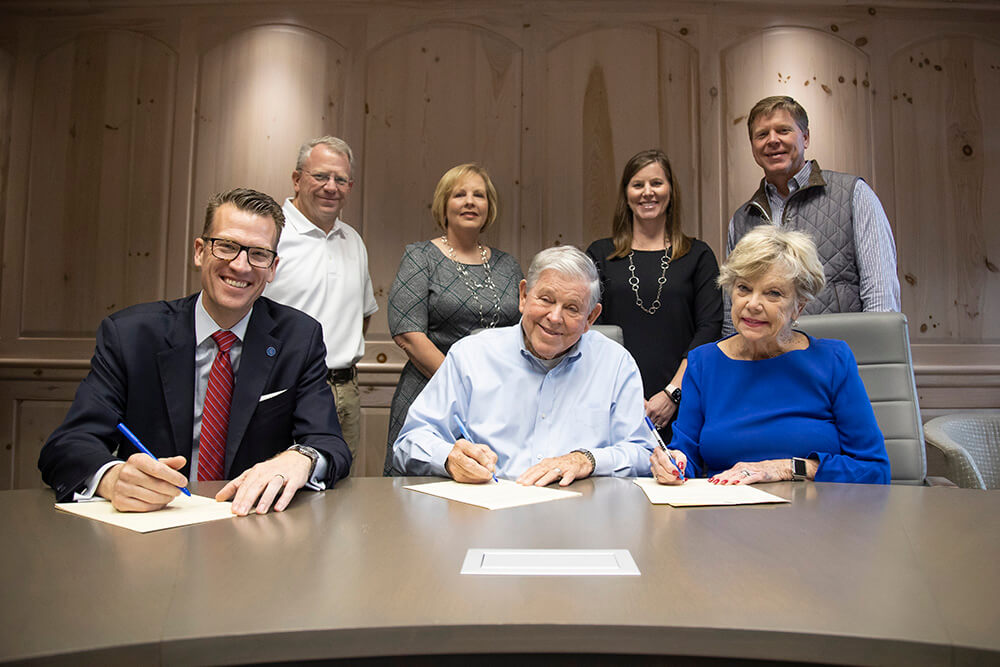 Front row: Dr. Brendan Kelly, 沙巴官网 president; Bob Stone, founder of SMI; Tish Stone, Bob's wife. Back row: Bart Stone, SMI's chief properties officer; Robin Custard, chief financial officer; Karen Middlebrooks, chief administrative officer; and Bill Stone, president of SMI