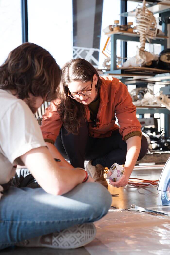 Lily Kuonen assists with UWG students' artwork