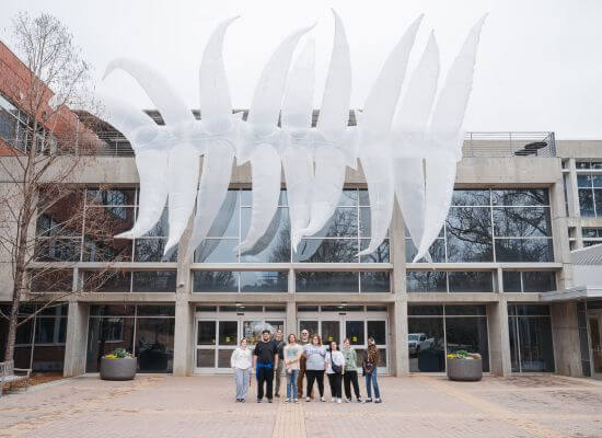 UWG students and visiting artists with their sculpture on campus
