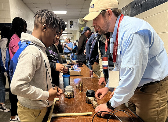 Newnan Utilities employee speaking to a student