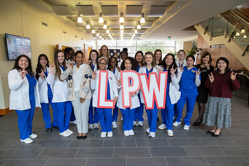 Group of 沙巴官网 nursing students holding the letters LPW