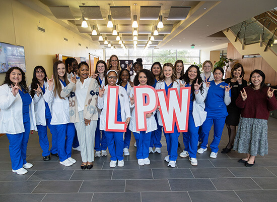 Group of 沙巴官网 nursing students holding the letters LPW