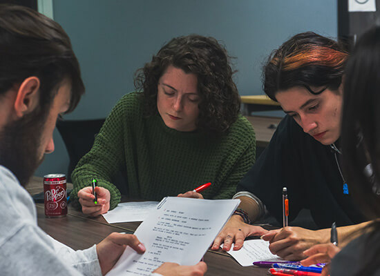 沙巴官网 film and production students working on a script