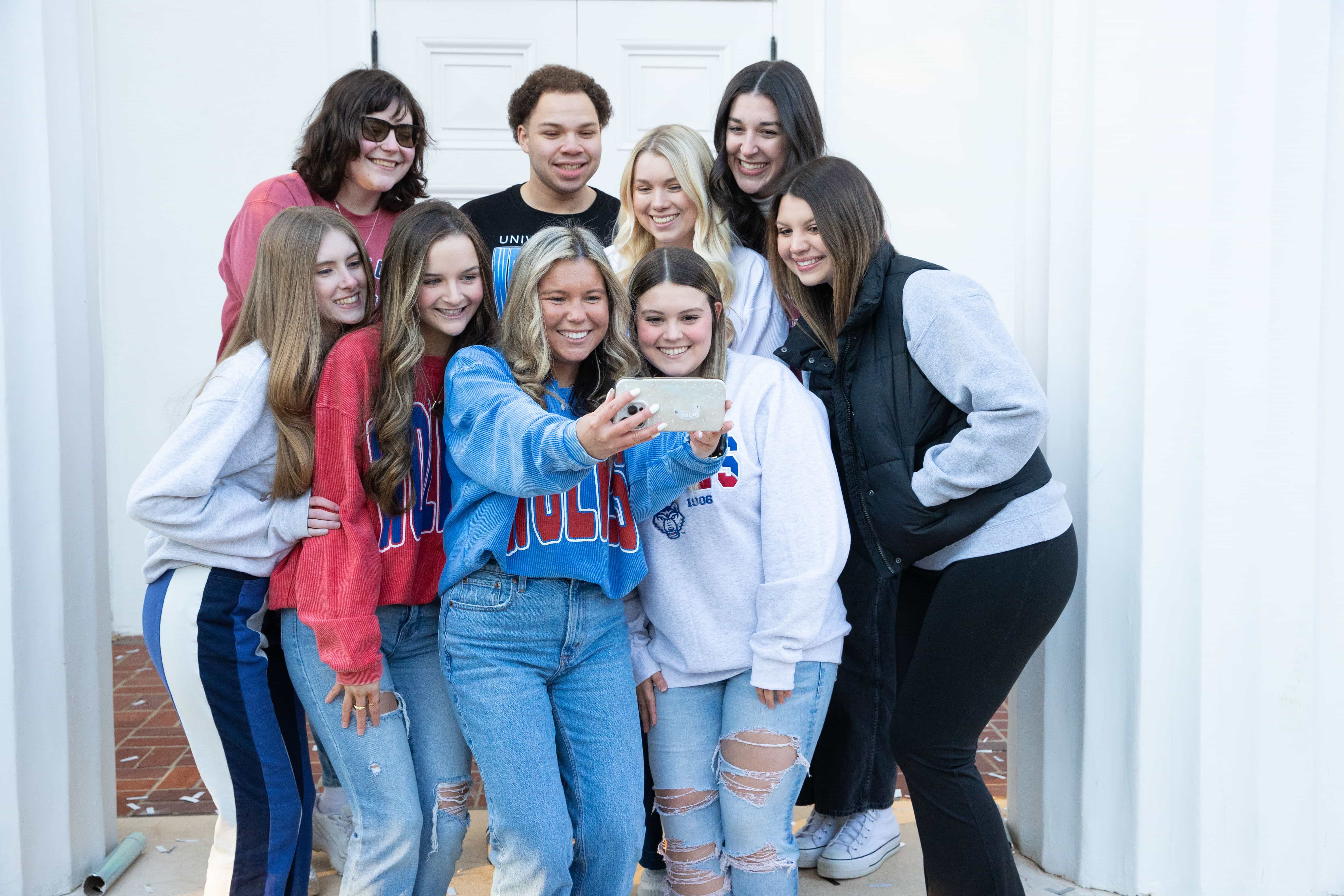Spring 2025 Social Media Ambassadors group together taking a selfie.