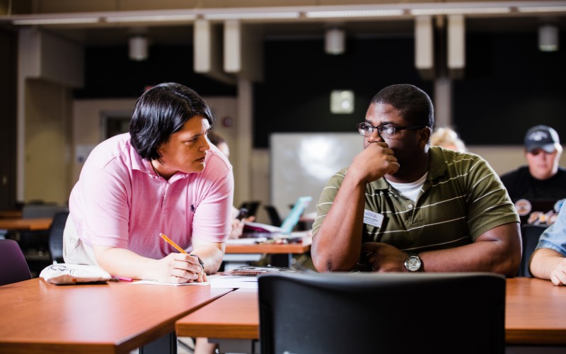 student sitting with professor