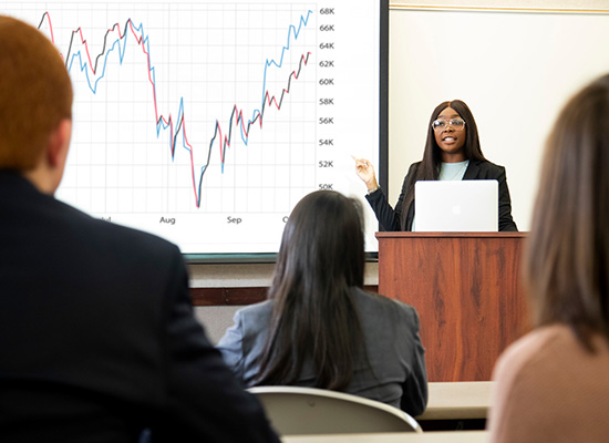 UWG Business student giving a presentation on economics.