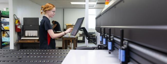 Two employees discussing a printing job