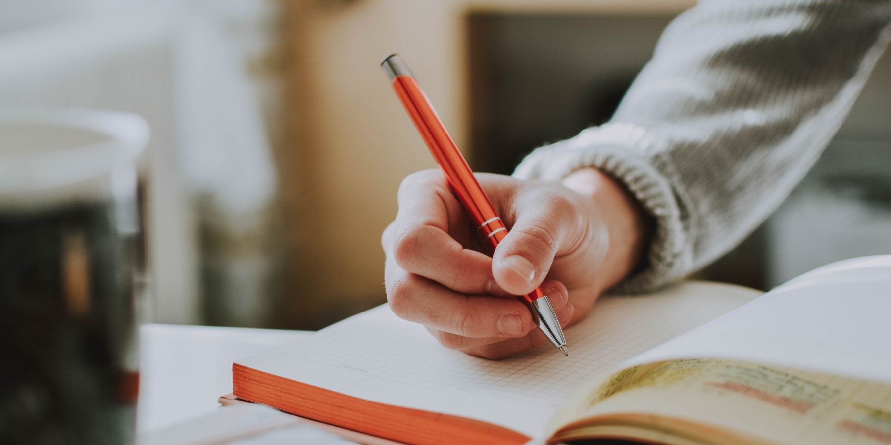 Person writing in a notebook.